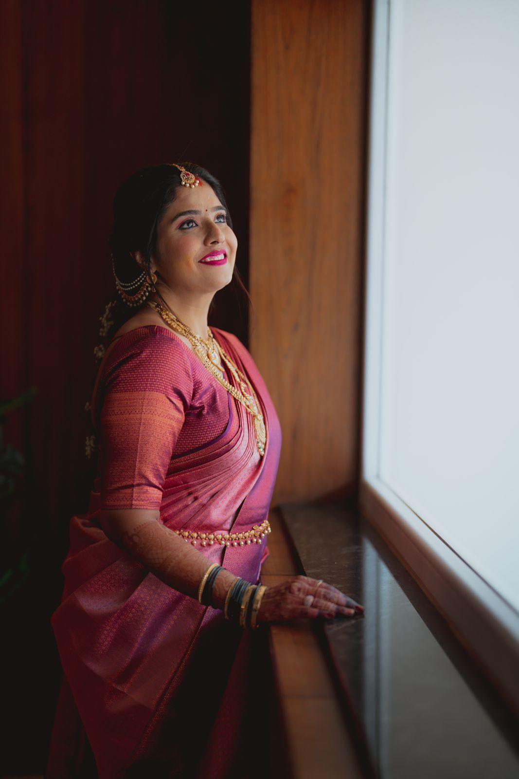 Shruthi in her golden lehenga at the window light