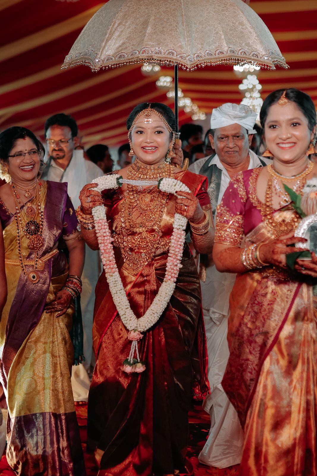 The bride beneath the ceremonial umbrella