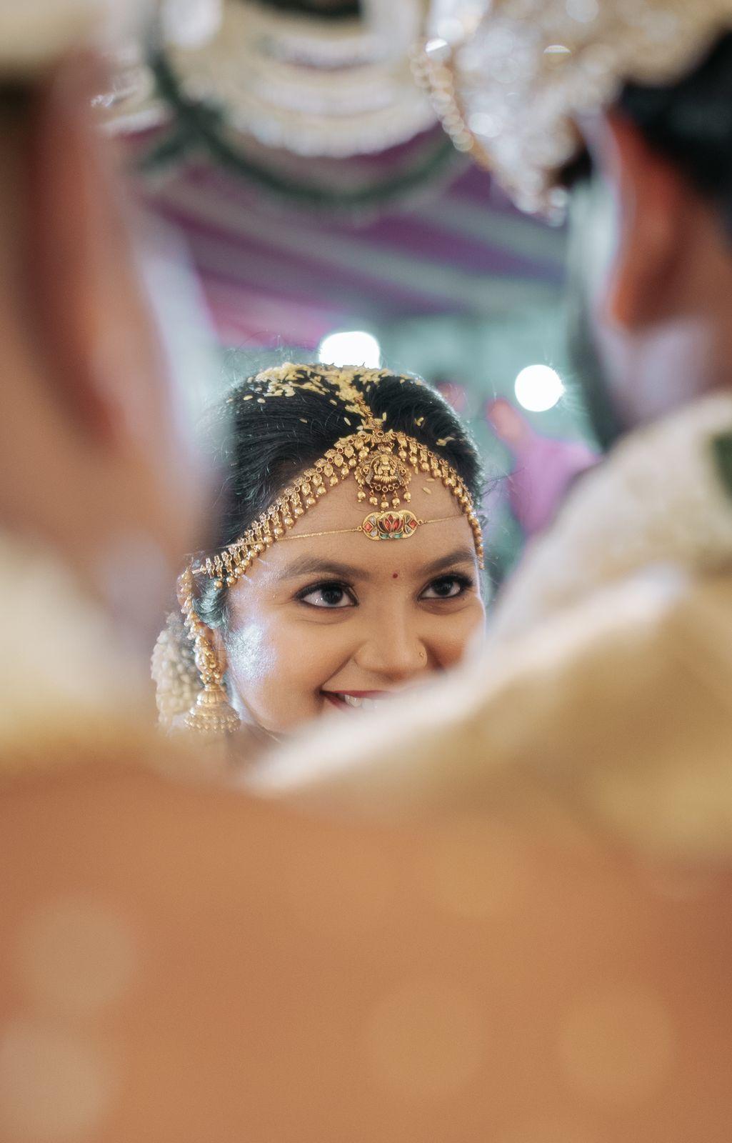 Ambika's smile caught in the mirror