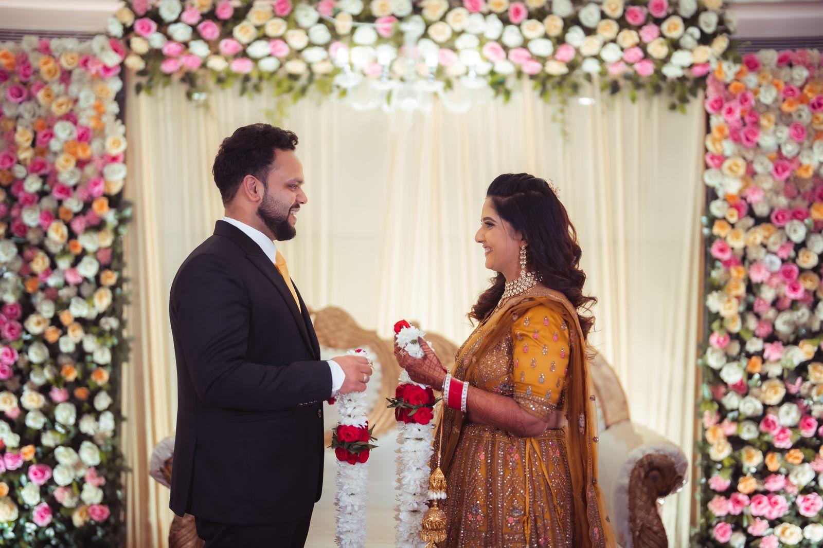 The exchange of rings before the floral wall